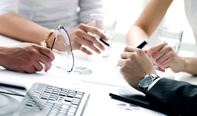 Four pairs of hands of business people in meeting Four pairs of hands of business people busy in meeting