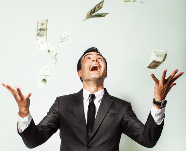 A happy man throwing cash up A man throwing cash up and smiling
