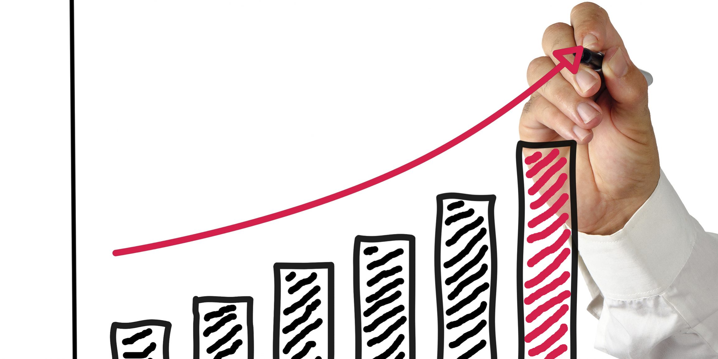 A man's hand drawing an arrow above chart