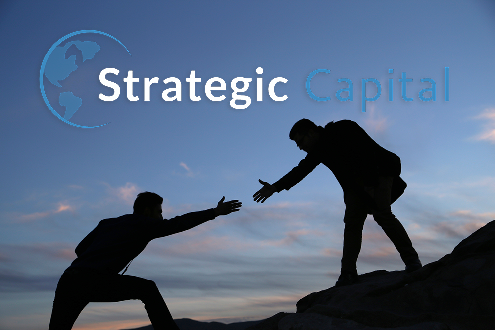 Strategic Capital logo Strategic Capital logo in which one man is helping other in climbing up