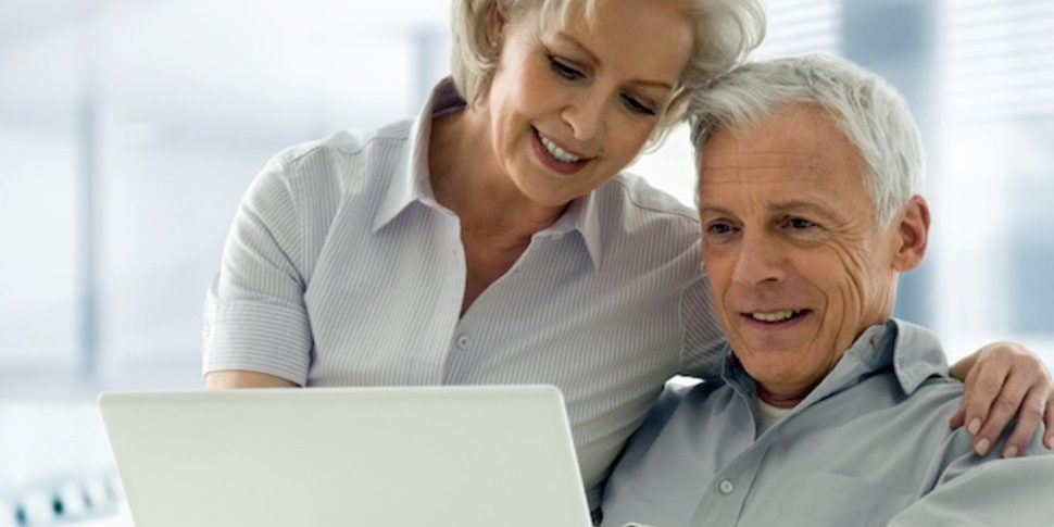 An old couple using laptop