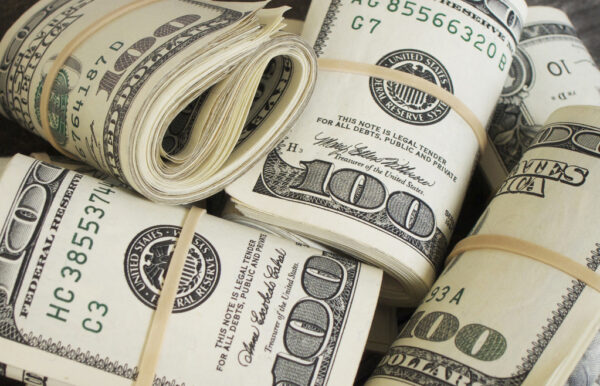 Folded piles of cash Folded piles of cash