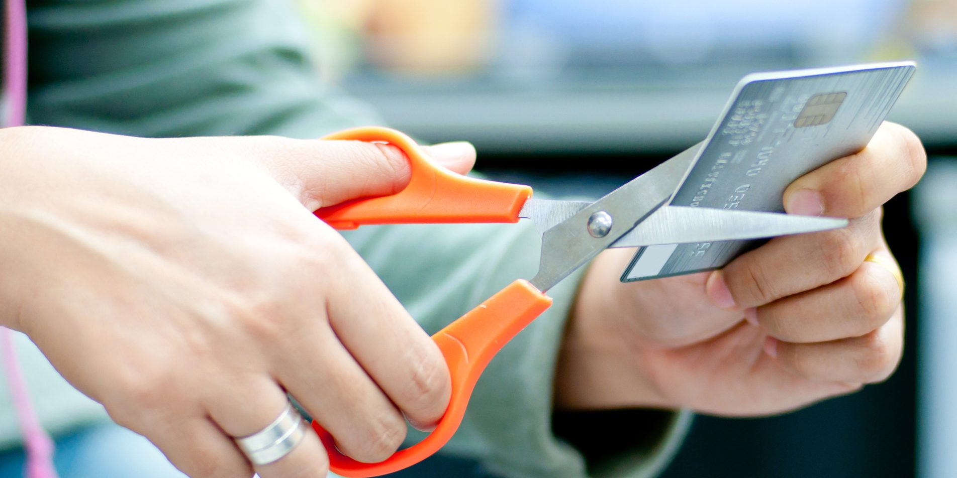 Cutting Credit Card Hands of a lady cutting credit card