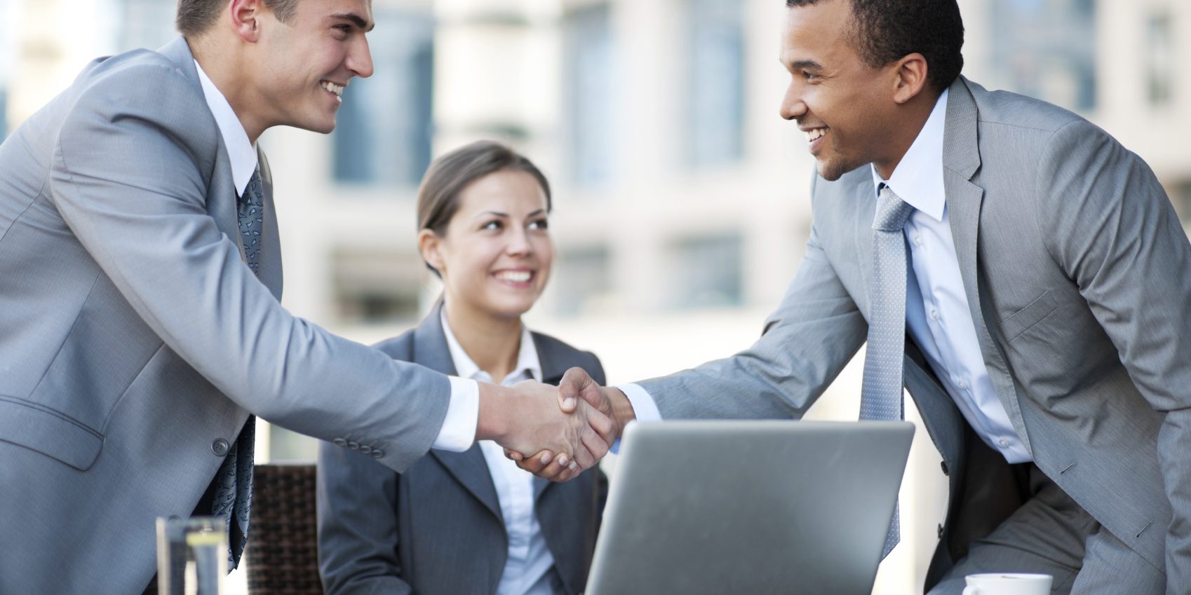 Young business people making a business deal.