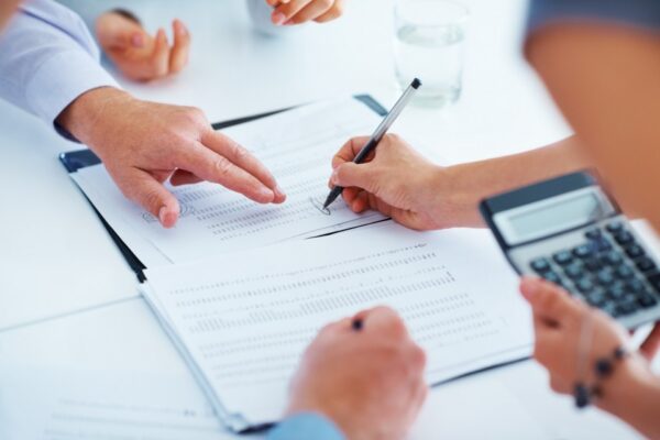 Business people discussing a business report Four business people discussing a business report