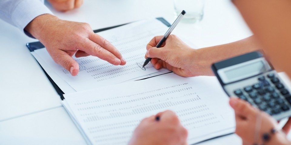 Business people discussing a business report Four business people discussing a business report