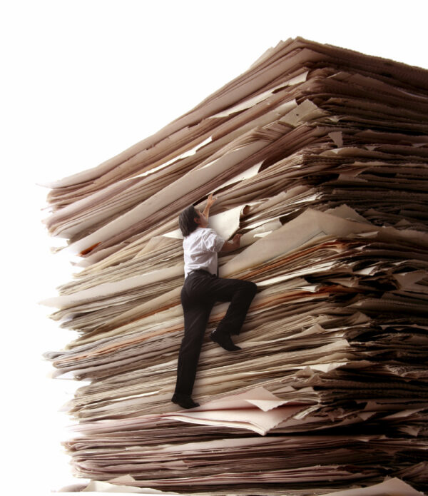Climbing a Pile of Files A man trying to climb a pile of fFiles