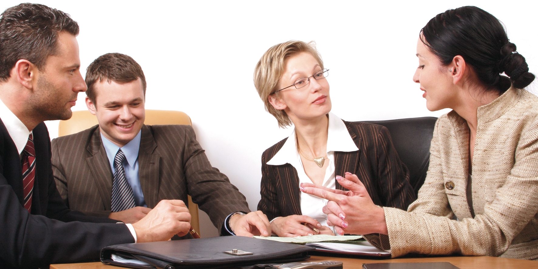 Four people during a meeting Two men and two women during a meeting
