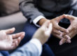Two pairs of hands of clients busy in discussion