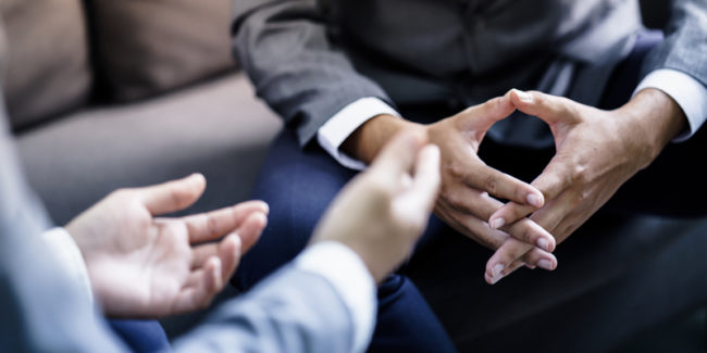 Two pairs of hands of clients busy in discussion