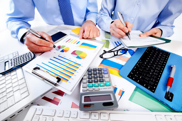 Two men working on a report Two men working on pie charts in a colorful report