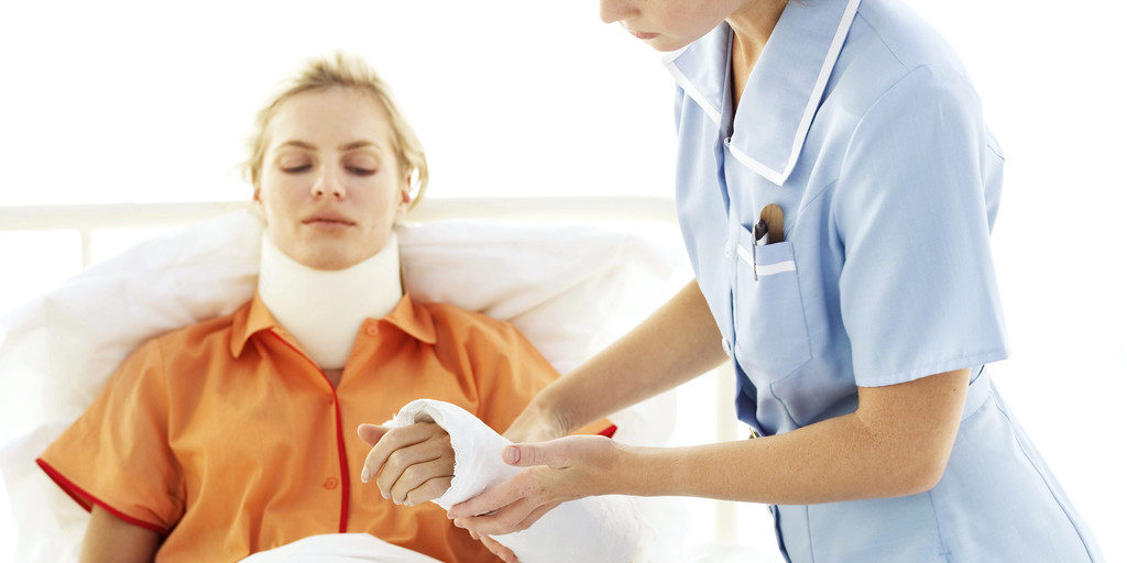 Young Nurse Tending to Young Woman with Neck Brace and Arm Cast