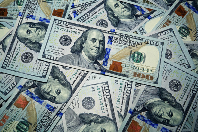 US Dollars US Dollars scattered over the background