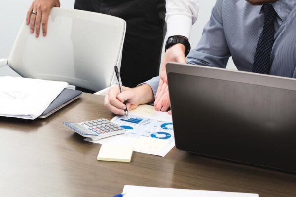 Two people busy in making a report Two people busy in making a business report