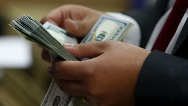 A hand of person counting cash A hand of person counting cash