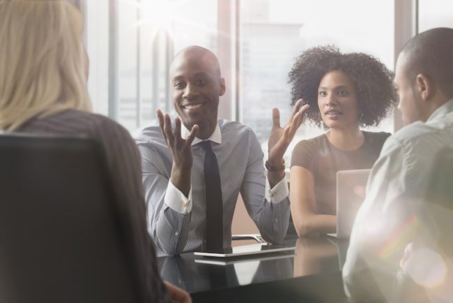 Business people in a meeting listening to one of them