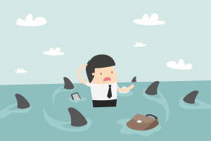 A man surrounded by sharks and is worried what to do